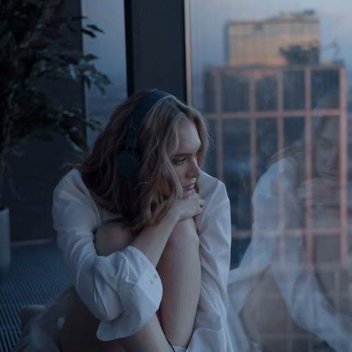 A_reflective_moment_as_a_woman_sits_by_the_window,_listening_to_music_while_gazing_at_the_cityscape_at_dusk_ours