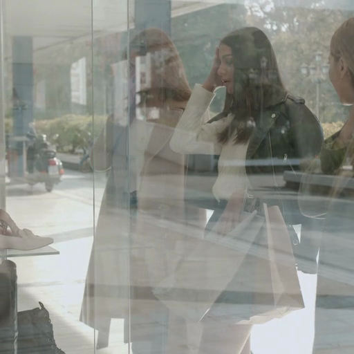 Three_women_window-shopping,_their_images_mirrored_in_the_storefront_ours